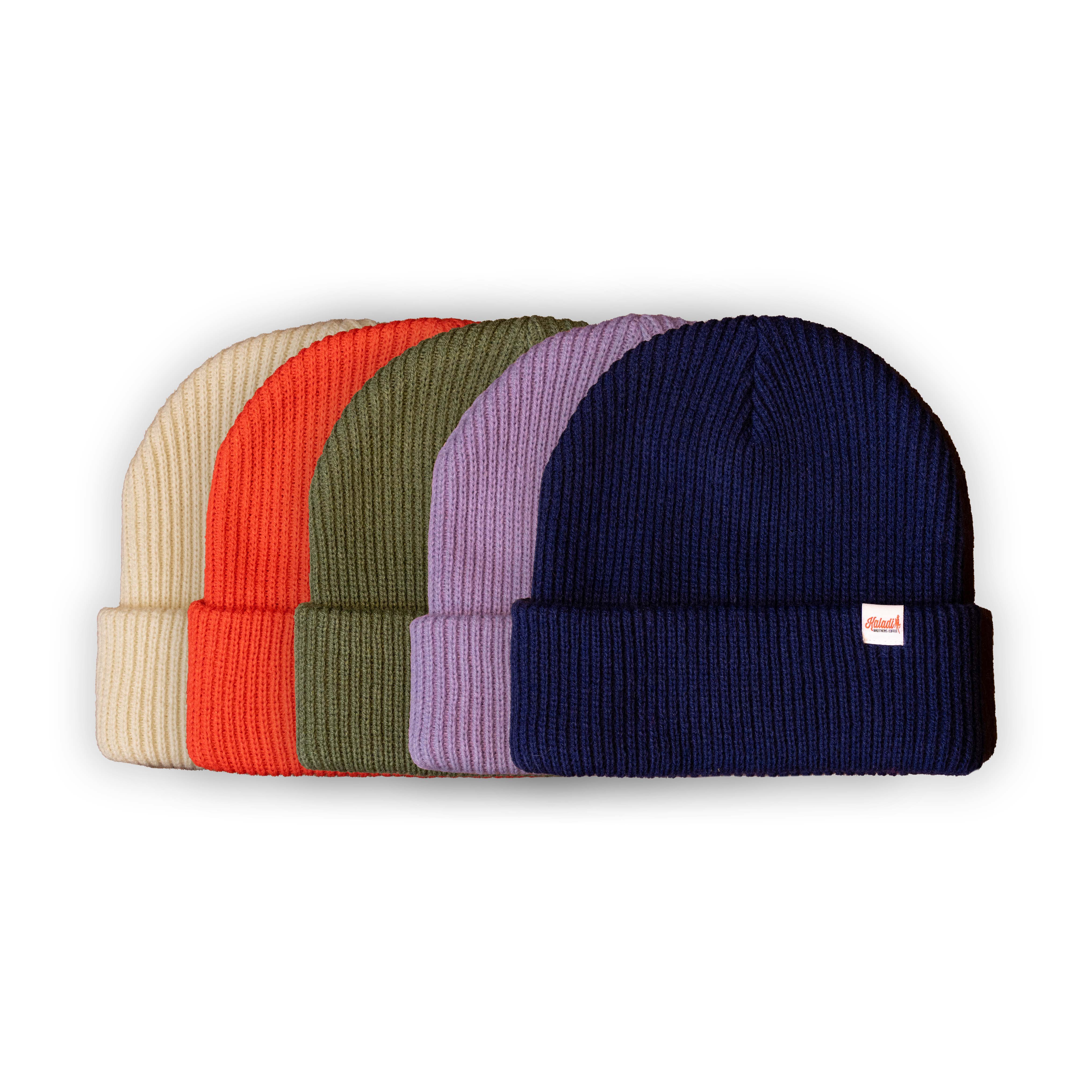 Multiple beanies in various colors stacked on each other