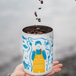 Coffee beans falling into the MiiR canister held in hand