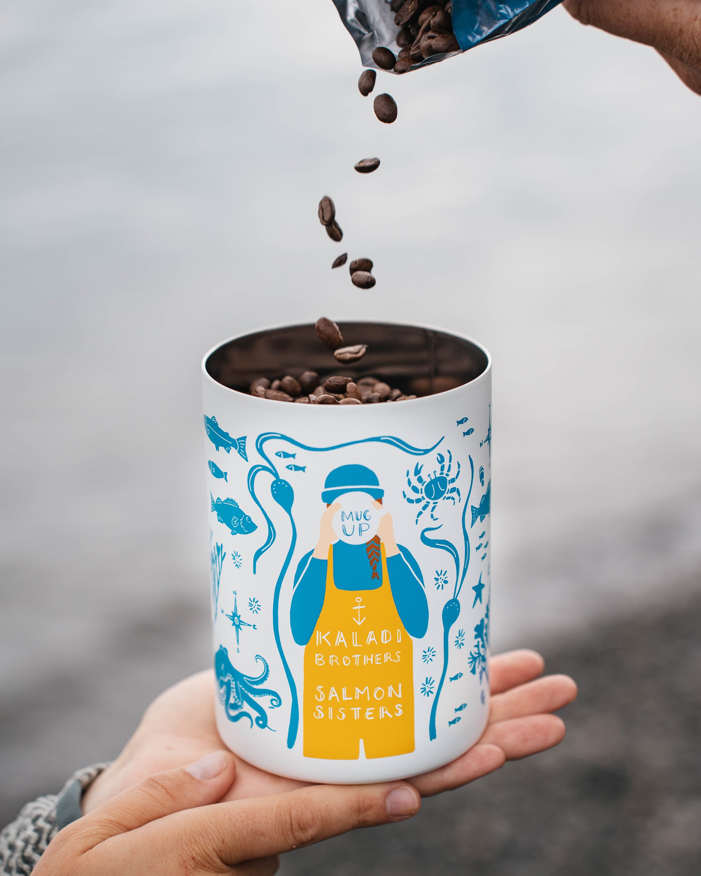 Coffee beans falling into the MiiR canister held in hand