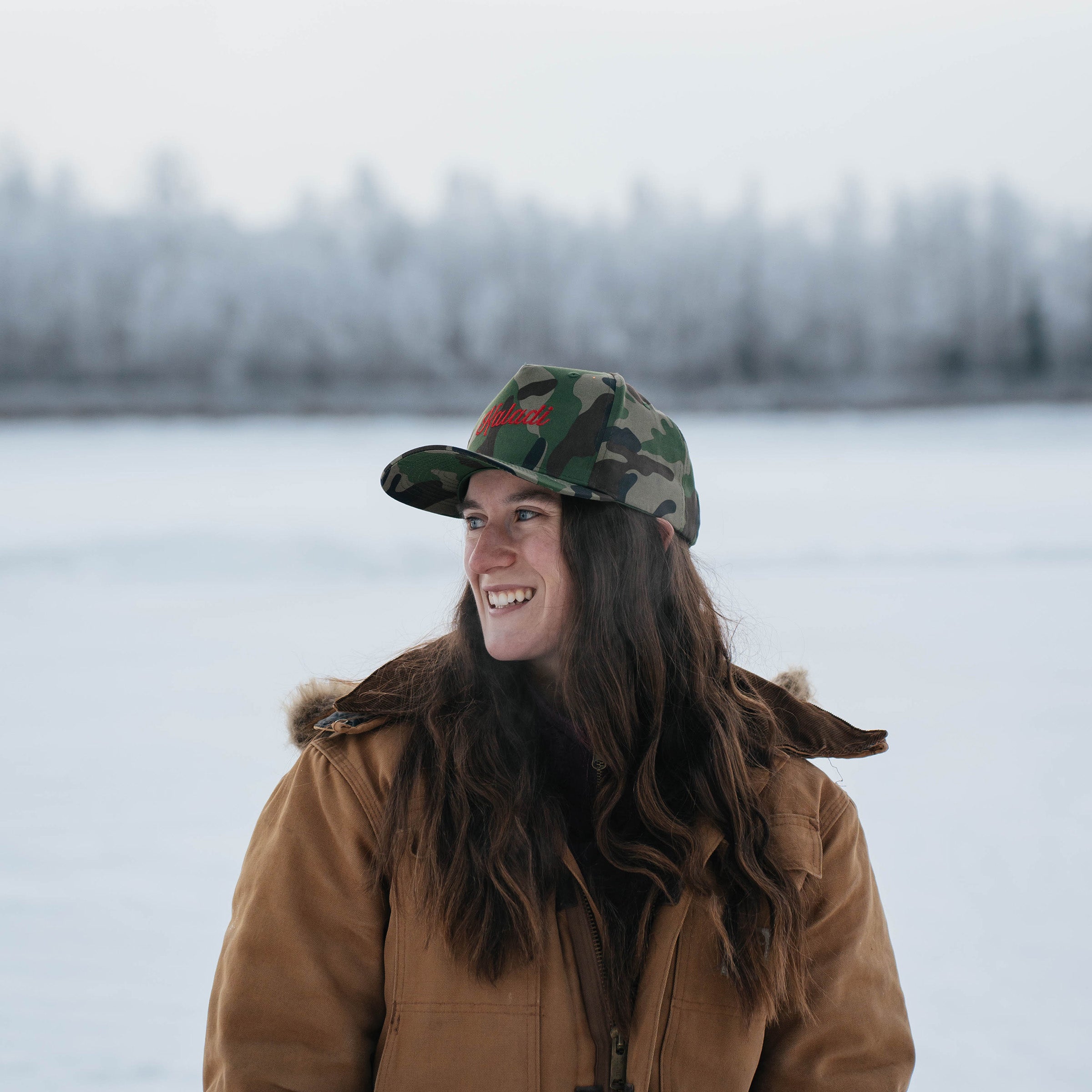 Woman wearing the Kaladi camo hat in winter
