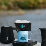 MiiR Pourigami dripper brewing on a blue camp mug riverside